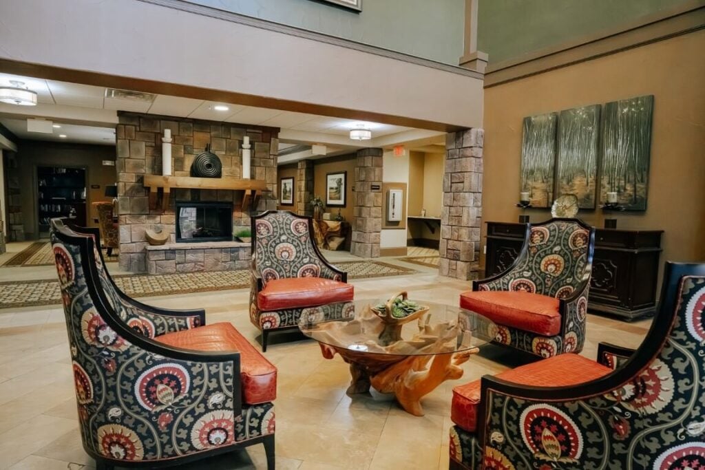 Elegant Lobby With Stone Fireplace at Assisted Living Kingwood TX