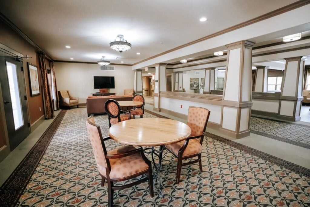 Spacious Community Room With Round Tables at Memory Care Kingwood TX
