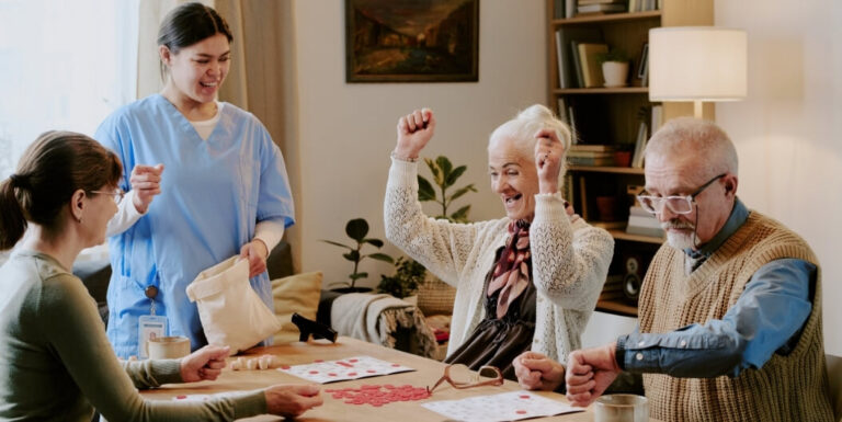 Seniors with Female Nurse Celebrating During Activity at Memory Care Facility